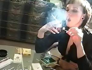 Older doxy holding a cancer stick increased by playing with herself